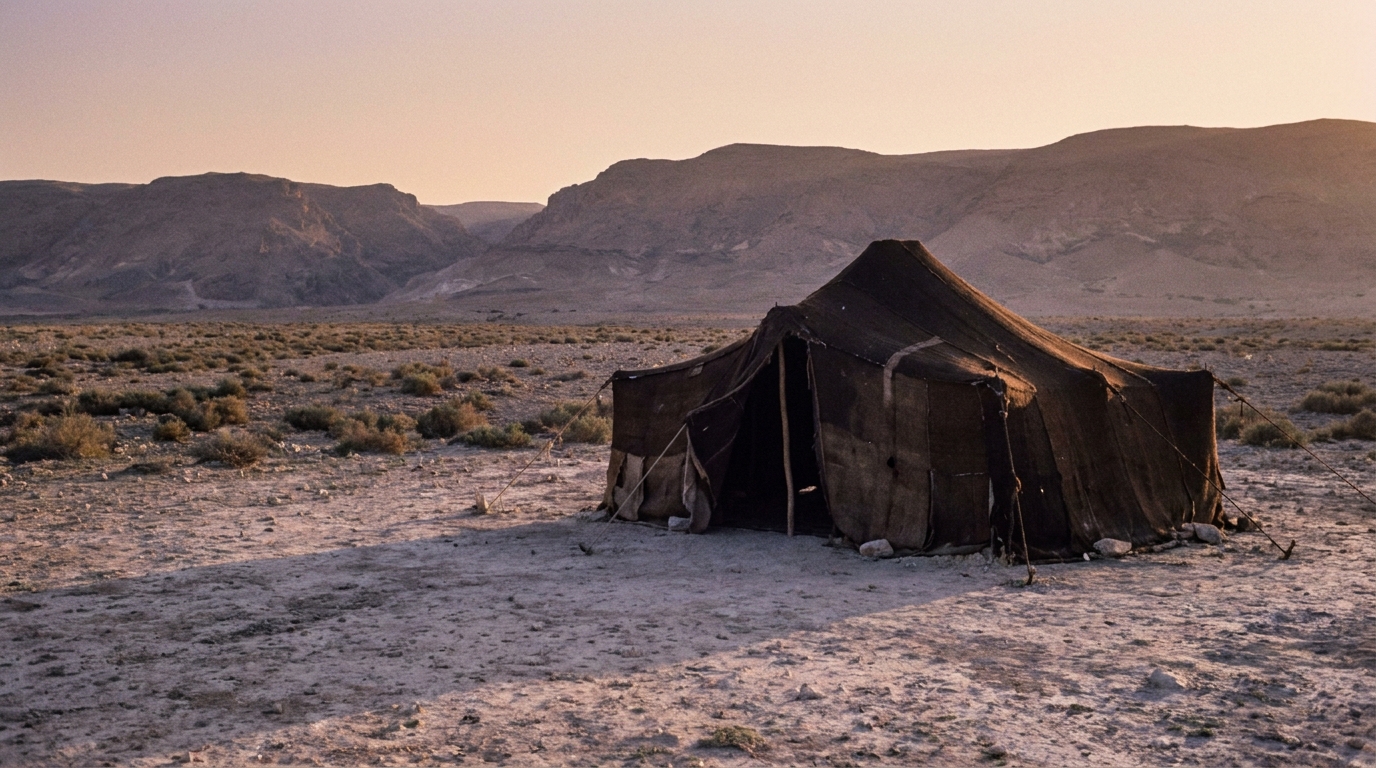A solitary goat-hair tent on a wide dry plain at dusk, empty and still, long shadows stretching across pale sand and low scrub toward distant hills under a soft warm sky, no people, no faces, no text